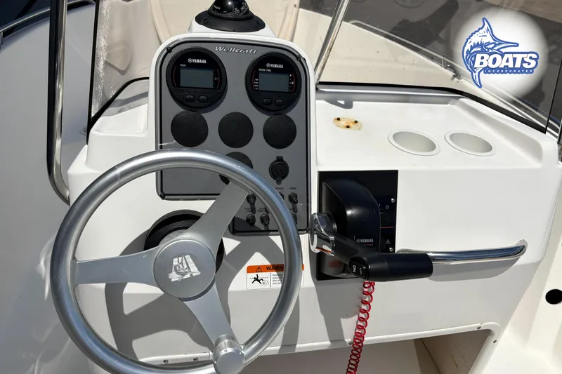 Slide: The Image of 2004 Wellcraft 180 Fisherman boat dashboard with steering wheel and Yamaha controls. - 8
