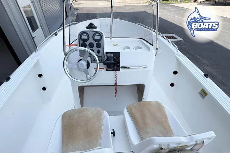 Slide: The Image of 2004 Wellcraft 180 Fisherman boat interior with steering wheel and dashboard controls. - 9