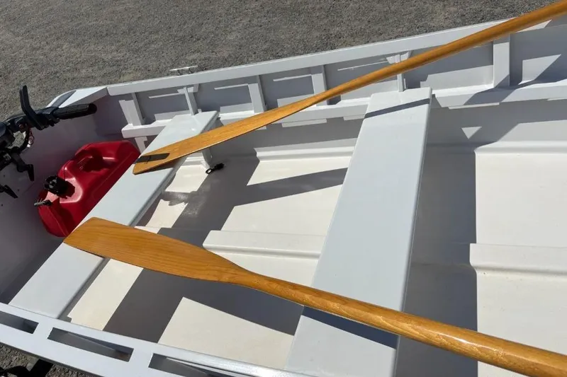 Slide: The Image of Interior of a 2006 Homebuilt V-HULL boat with wooden oars and a red fuel tank. - 7