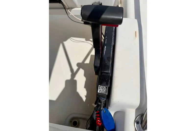 Slide: The Image of Throttle control of a 2002 Boston Whaler 130 Sport boat, featuring safety lanyard. - 12
