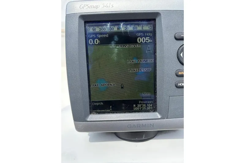 Slide: The Image of Garmin GPS device displaying map with lakes and coordinates on a Boston Whaler 130 Sport boat. - 21