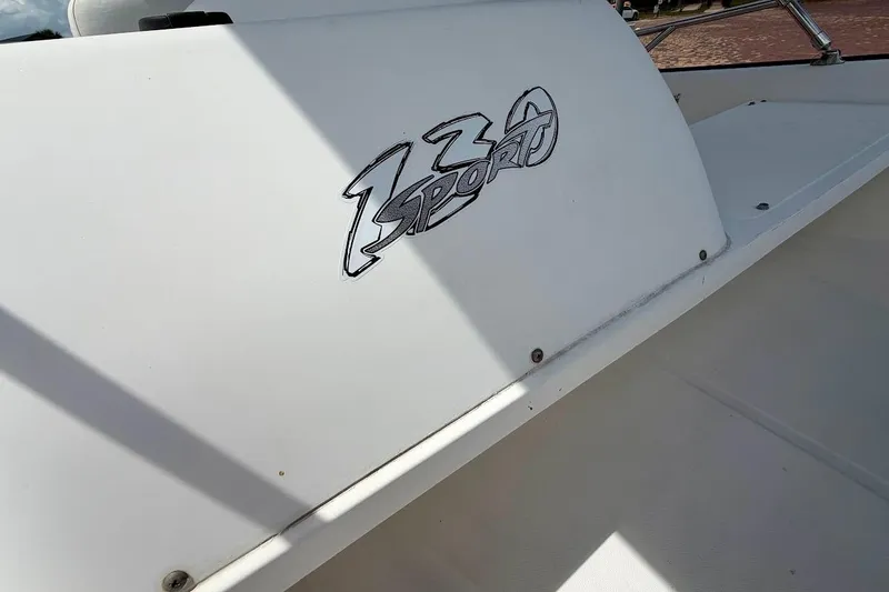 Slide: The Image of 2002 Boston Whaler 130 Sport boat logo on white surface. - 7
