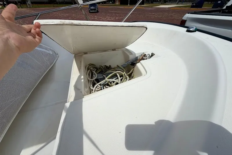 Slide: The Image of Open storage compartment on 2002 Boston Whaler 130 Sport boat with ropes inside. - 8