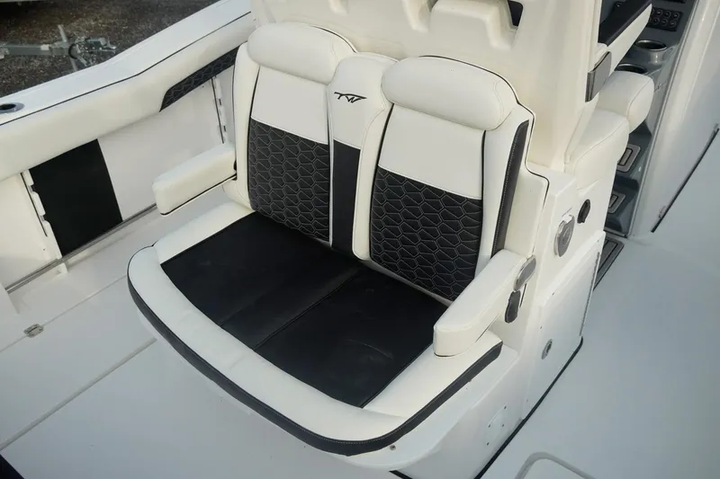 Slide: The Image of 2026 Tidewater 282 CC Adventure boat seating with black and white upholstery. - 10