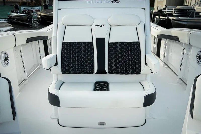Slide: The Image of 2026 Tidewater 282 CC Adventure boat interior with stylish seating and cup holders. - 12