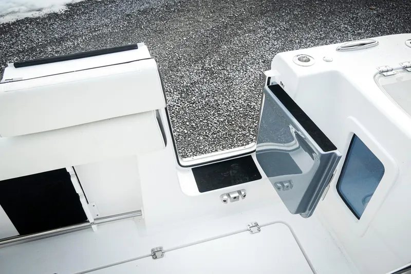Slide: The Image of 2026 Tidewater 282 CC Adventure boat interior with open hatch and seating. - 16