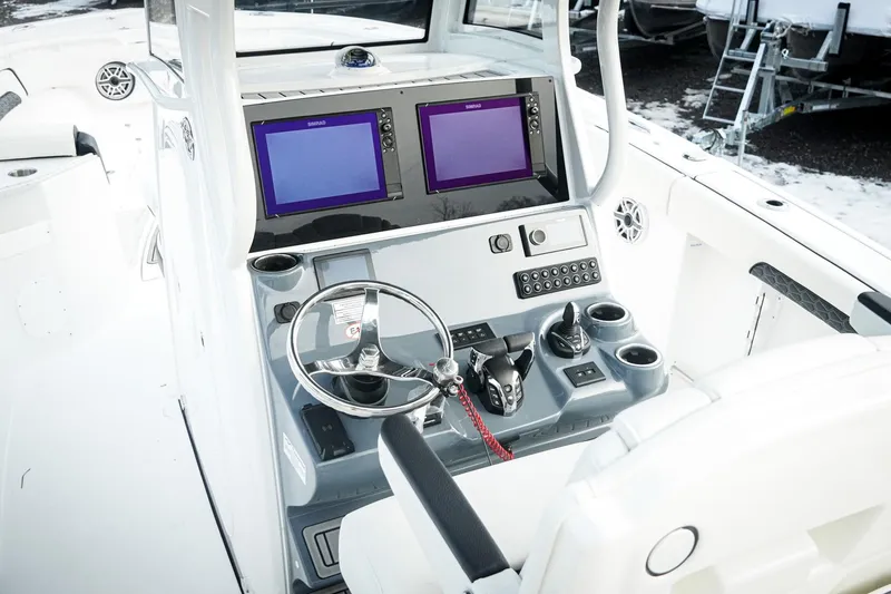 Slide: The Image of Helm of 2026 Tidewater 282 CC Adventure boat with dual screens and controls. - 4