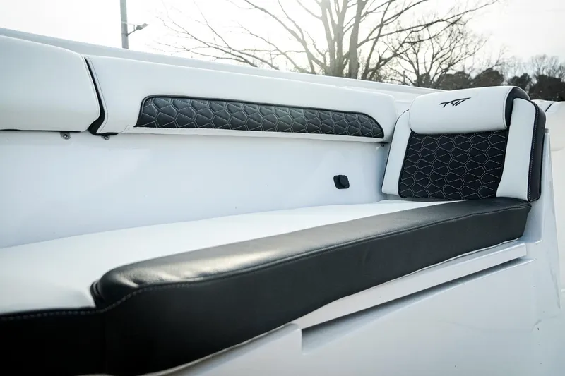 Slide: The Image of 2026 Tidewater 282 CC Adventure boat interior with stylish black and white seating. - 6