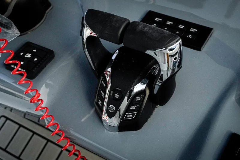 Slide: The Image of Throttle controls on 2026 Tidewater 282 CC Adventure boat dashboard. - 9