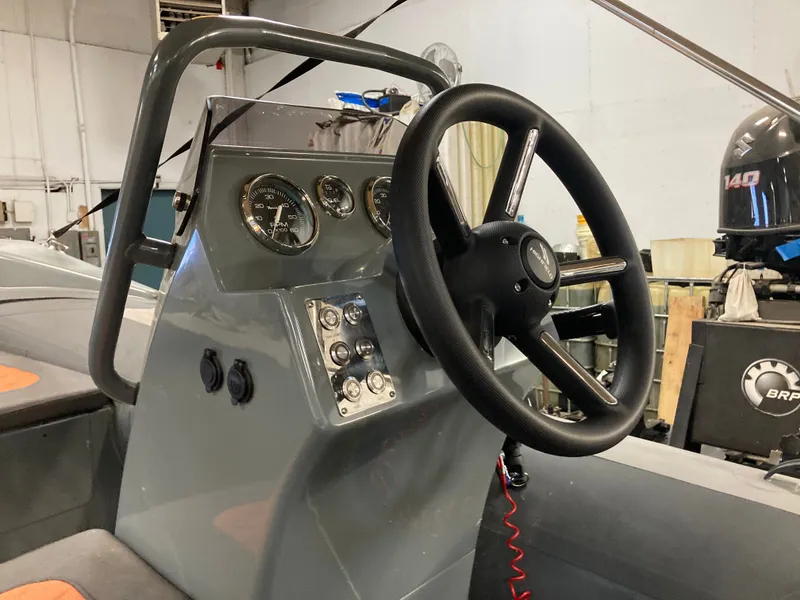 Slide: The Image of 2023 Highfield Sport 360 boat console with steering wheel and gauges. - 8