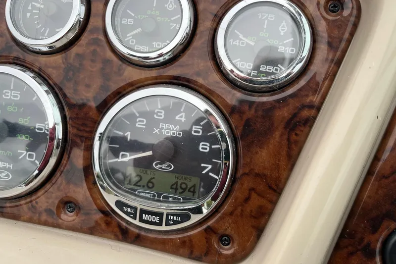 Slide: The Image of Dashboard gauges of a 2004 Sea Ray 240 Sundancer boat, showing RPM and voltage. - 17