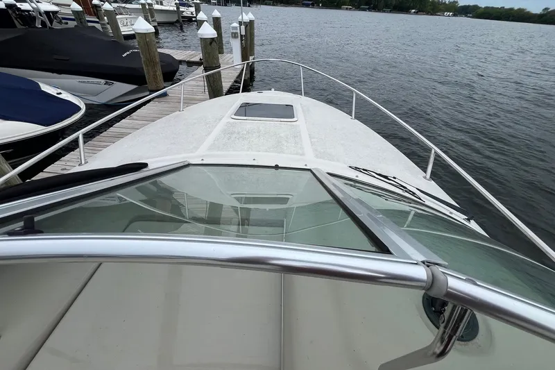 Slide: The Image of 2004 Sea Ray 240 Sundancer boat docked at marina, view from bow. - 18