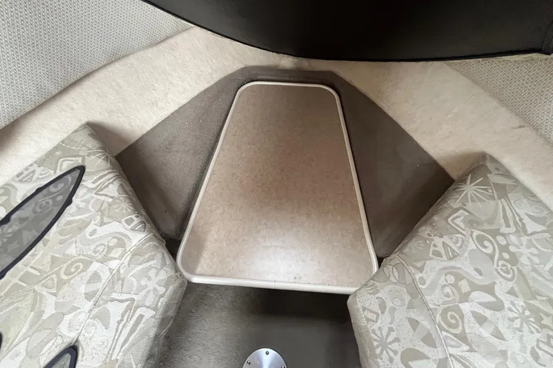 Slide: The Image of Interior cabin of 2004 Sea Ray 240 Sundancer with patterned seating and table. - 26