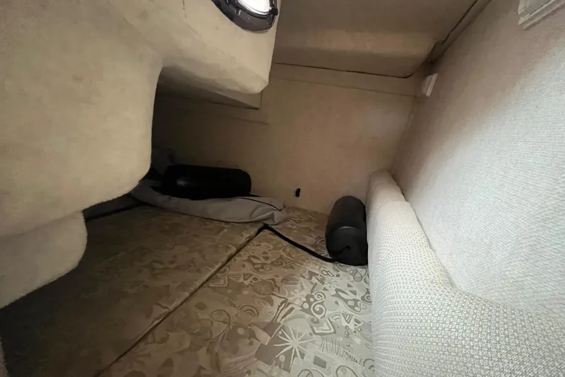 Slide: The Image of Interior cabin of 2004 Sea Ray 240 Sundancer boat, featuring cozy sleeping area. - 32