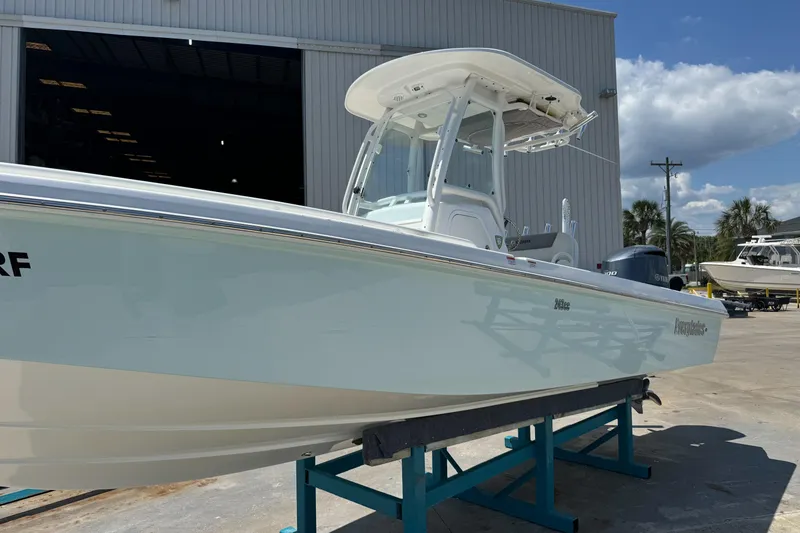 Slide: The Image of 2017 Everglades 243 Center Console boat on display outside a warehouse. - 3