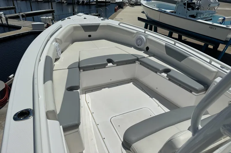 Slide: The Image of 2017 Everglades 243 Center Console boat interior with cushioned seating at marina. - 5