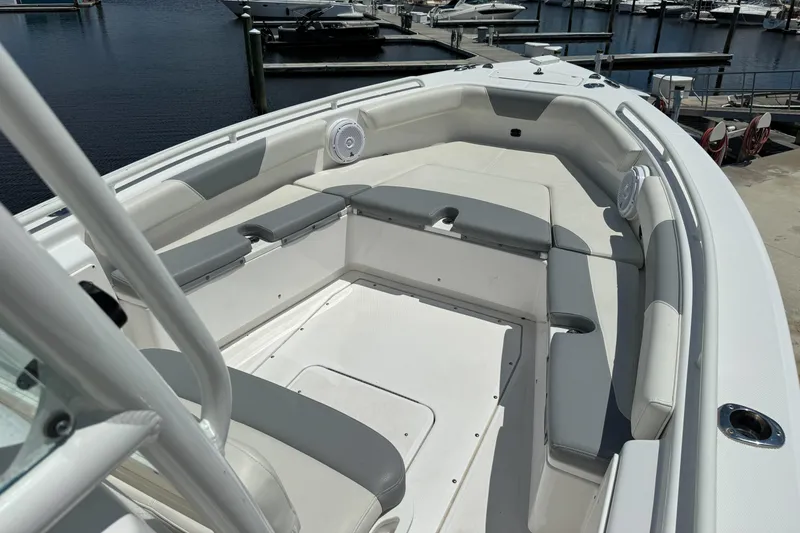Slide: The Image of 2017 Everglades 243 Center Console boat interior with cushioned seating at marina. - 6