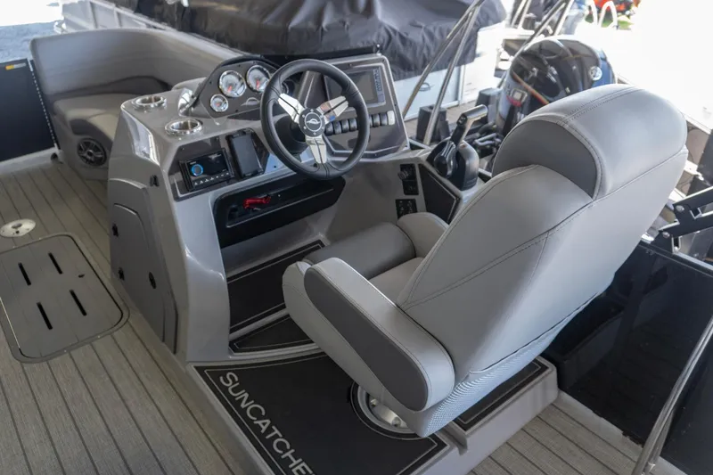 Slide: The Image of Helm of 2026 SunCatcher Fusion 324SL boat with modern controls and seating. - 5