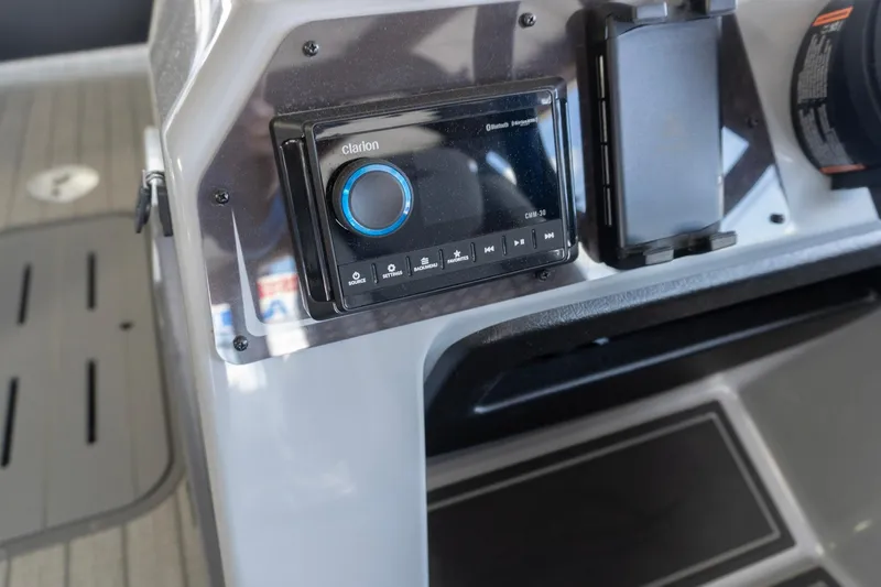Slide: The Image of Clarion audio system on 2026 SunCatcher Fusion 324SL boat dashboard. - 6