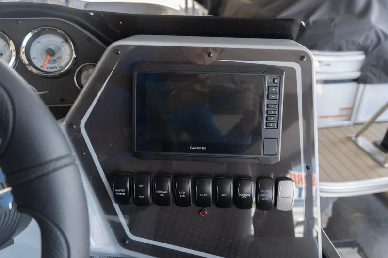 Slide: The Image of Dashboard of 2026 SunCatcher Fusion 324SL with Garmin display and control switches. - 7