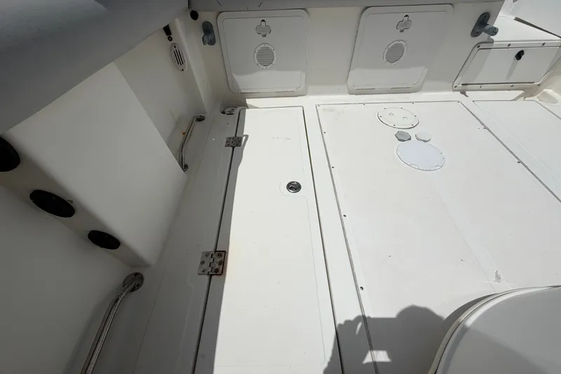 Slide: The Image of Interior deck of a 2011 Jefferson Marlago FS35 boat, featuring storage compartments. - 84