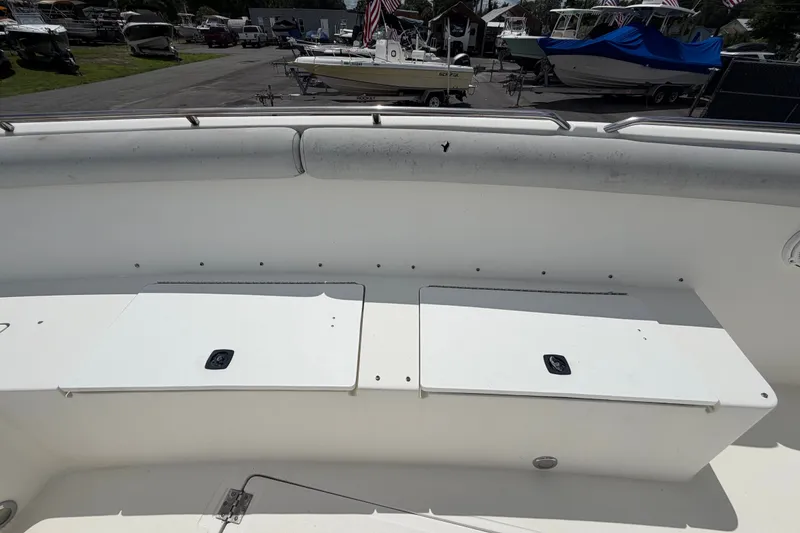Slide: The Image of 2011 Jefferson Marlago FS35 boat deck with storage compartments, parked among other boats. - 63