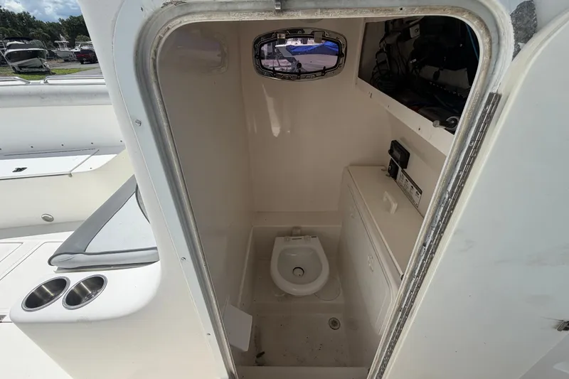 Slide: The Image of Interior of a 2011 Jefferson Marlago FS35 boat showing a compact marine toilet. - 48
