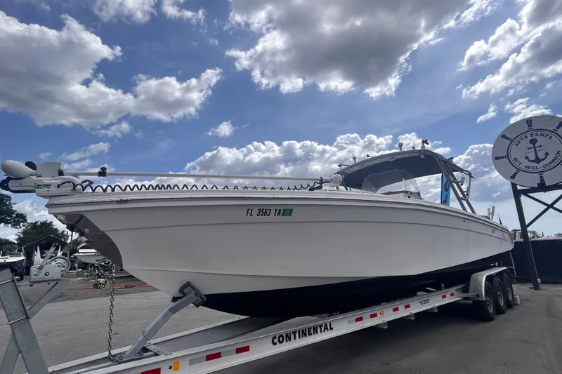 Slide: The Image of White Jefferson Marlargo FS35 boat on trailer under a partly cloudy sky, 2011 model. - 11