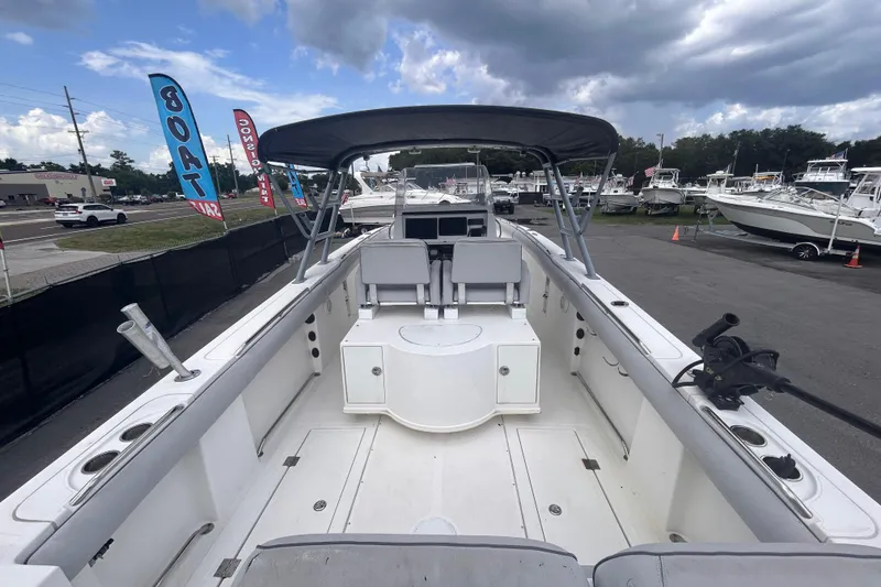 Slide: The Image of 2011 Jefferson Marlargo FS35 boat interior with canopy, docked at marina under cloudy sky. - 14