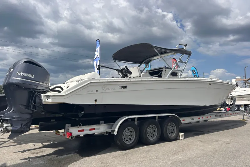 Slide: The Image of 2011 Jefferson Marlargo FS35 boat on trailer with Yamaha engine under cloudy sky. - 2