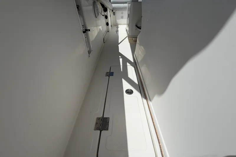 Slide: The Image of Interior view of a 2011 Jefferson Marlago FS35 boat, showcasing sleek white design. - 76