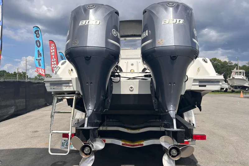 Slide: The Image of Twin Yamaha 300 engines on a 2011 Jefferson Marlargo FS35 boat, displayed outdoors. - 4