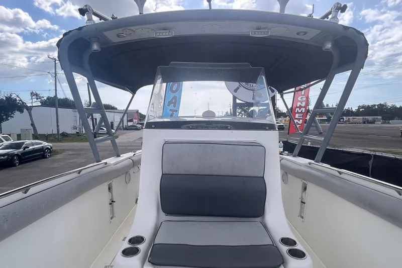 Slide: The Image of 2011 Jefferson Marlargo FS35 boat interior with seating and canopy under a cloudy sky. - 44