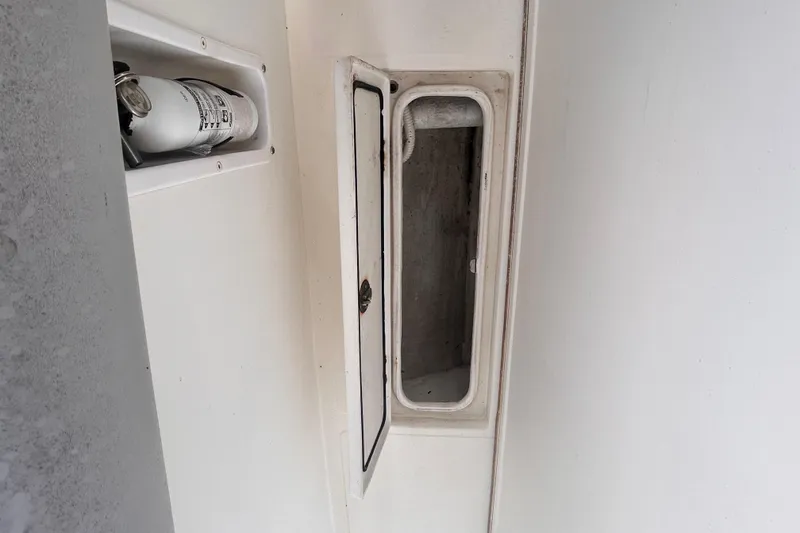 Slide: The Image of Fire extinguisher and storage compartment on a 2011 Jefferson Marlargo FS35 boat. - 48