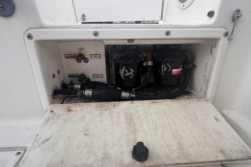 Slide: The Image of Boat engine compartment of a 2011 Jefferson Marlargo FS35, showing fuel filters and hoses. - 54