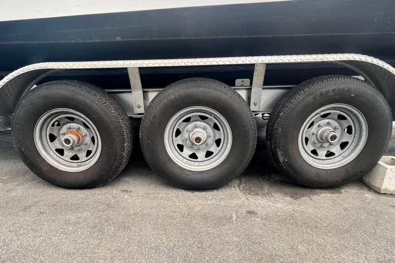 Slide: The Image of Triple axle trailer wheels of a 2011 Jefferson Marlargo FS35 on pavement. - 61