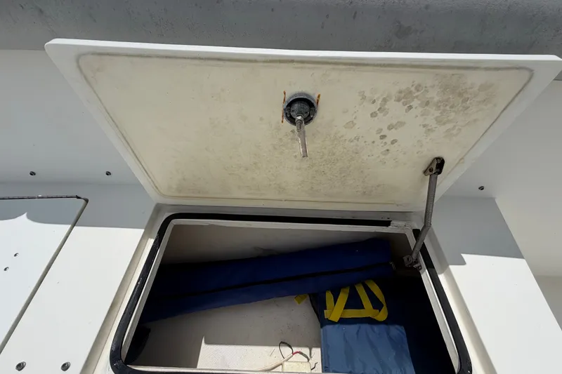 Slide: The Image of Open storage compartment on 2011 Jefferson Marlago FS35 boat, showing interior contents. - 64
