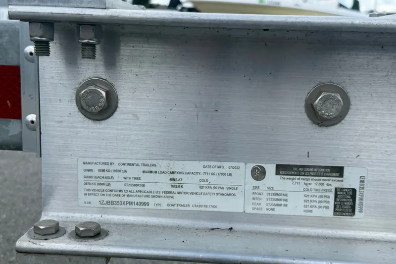 Slide: The Image of Label on metal trailer frame with specifications and safety standards. - 95