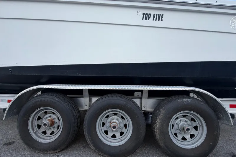 Slide: The Image of 2011 Jefferson Marlago FS35 boat on trailer with triple axle wheels. - 96
