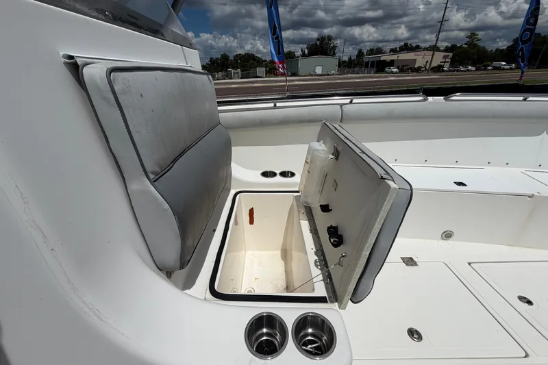 Slide: The Image of 2011 Jefferson Marlago FS35 boat interior with open storage compartment and cup holders. - 74