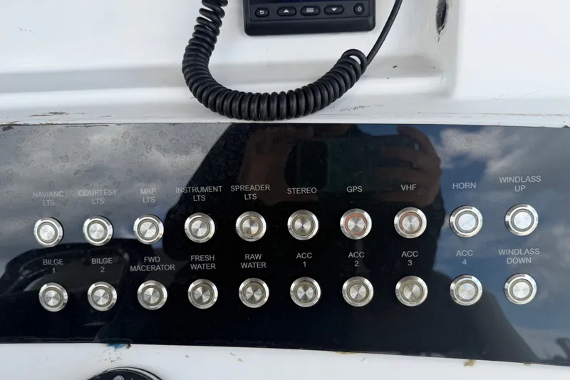 Slide: The Image of Control panel of a 2011 Jefferson Marlago FS35 boat with various labeled switches. - 40
