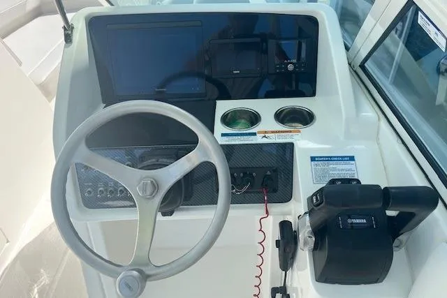 Slide: The Image of 2024 World Cat 230 SD helm with steering wheel, controls, and display screens. - 4