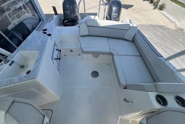Slide: The Image of 2024 World Cat 230 SD boat interior with spacious seating and dual 115 engines. - 6