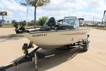 Slide: The Image of 2020 Tracker Pro Guide V-165 WT boat on trailer, parked outdoors. - 6