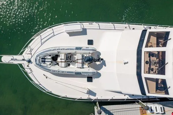Slide: The Image of Aerial view of 1993 Viking Convertible yacht docked on calm green water. - 10