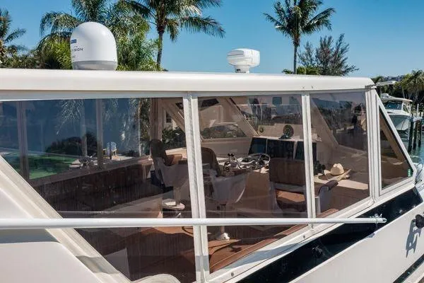 Slide: The Image of 1993 Viking Convertible yacht interior with helm, chairs, and tropical backdrop. - 13