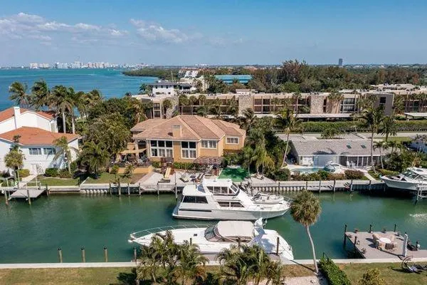 Slide: The Image of Aerial view of a 1993 Viking Convertible yacht docked by waterfront homes. - 16
