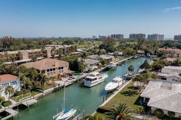 Slide: The Image of Aerial view of waterfront homes and boats, featuring a 1993 Viking Convertible yacht. - 18