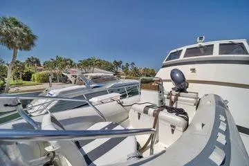 Slide: The Image of 1993 Viking Convertible yacht docked, featuring sleek design and tropical surroundings. - 21