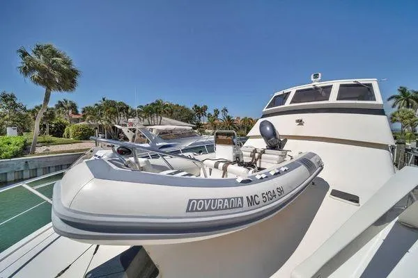 Slide: The Image of 1993 Viking Convertible yacht with Novurania tender, docked in a sunny marina. - 23